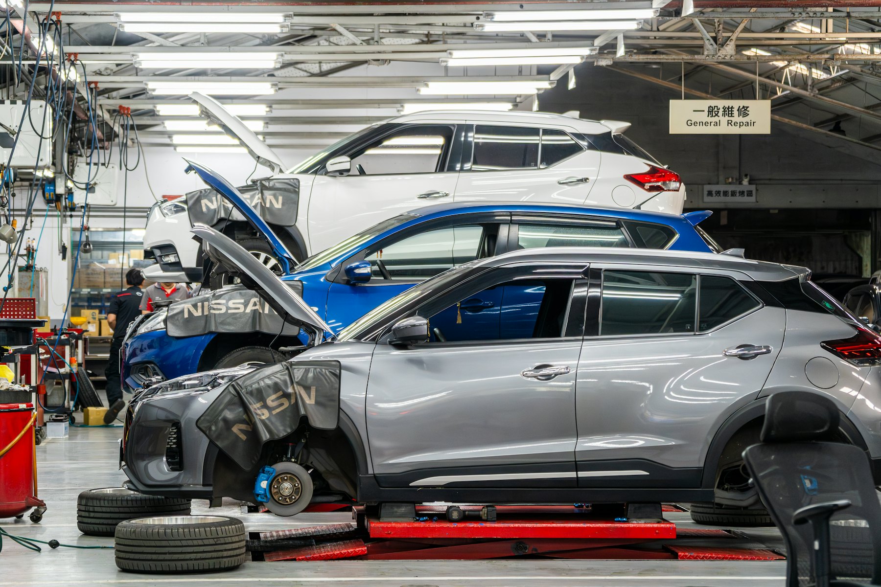 Vehicles on hoists in a dealership service bay